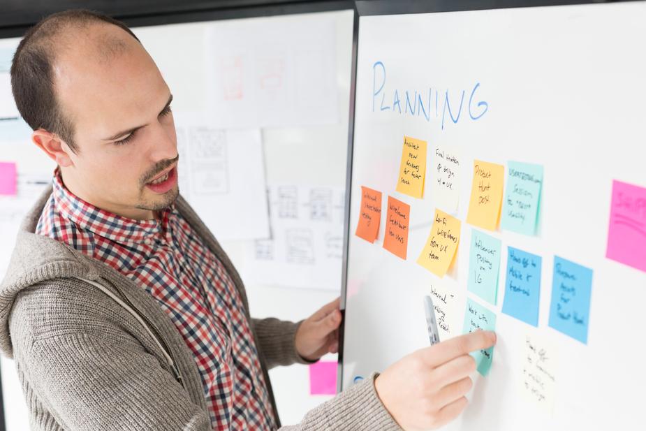 Man planning at white board