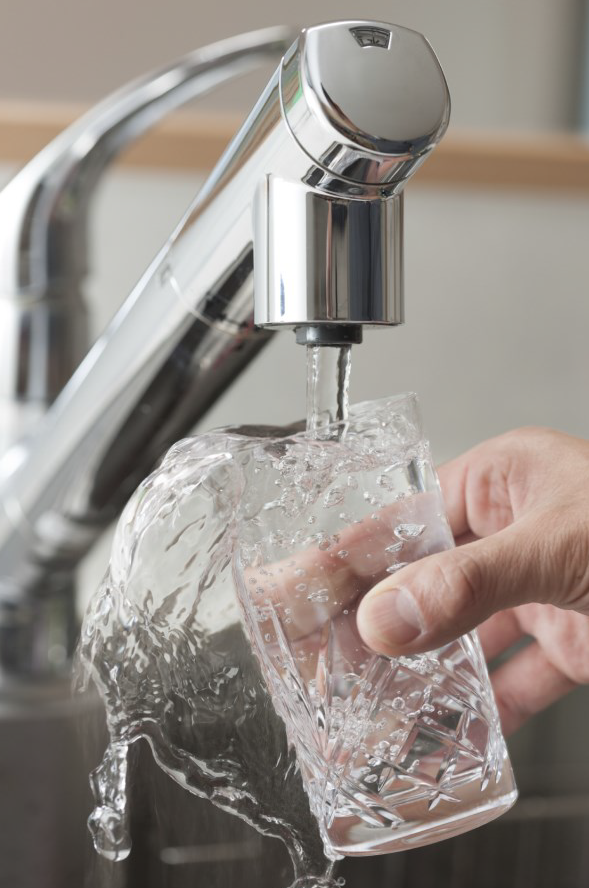 filling glass of water under tap